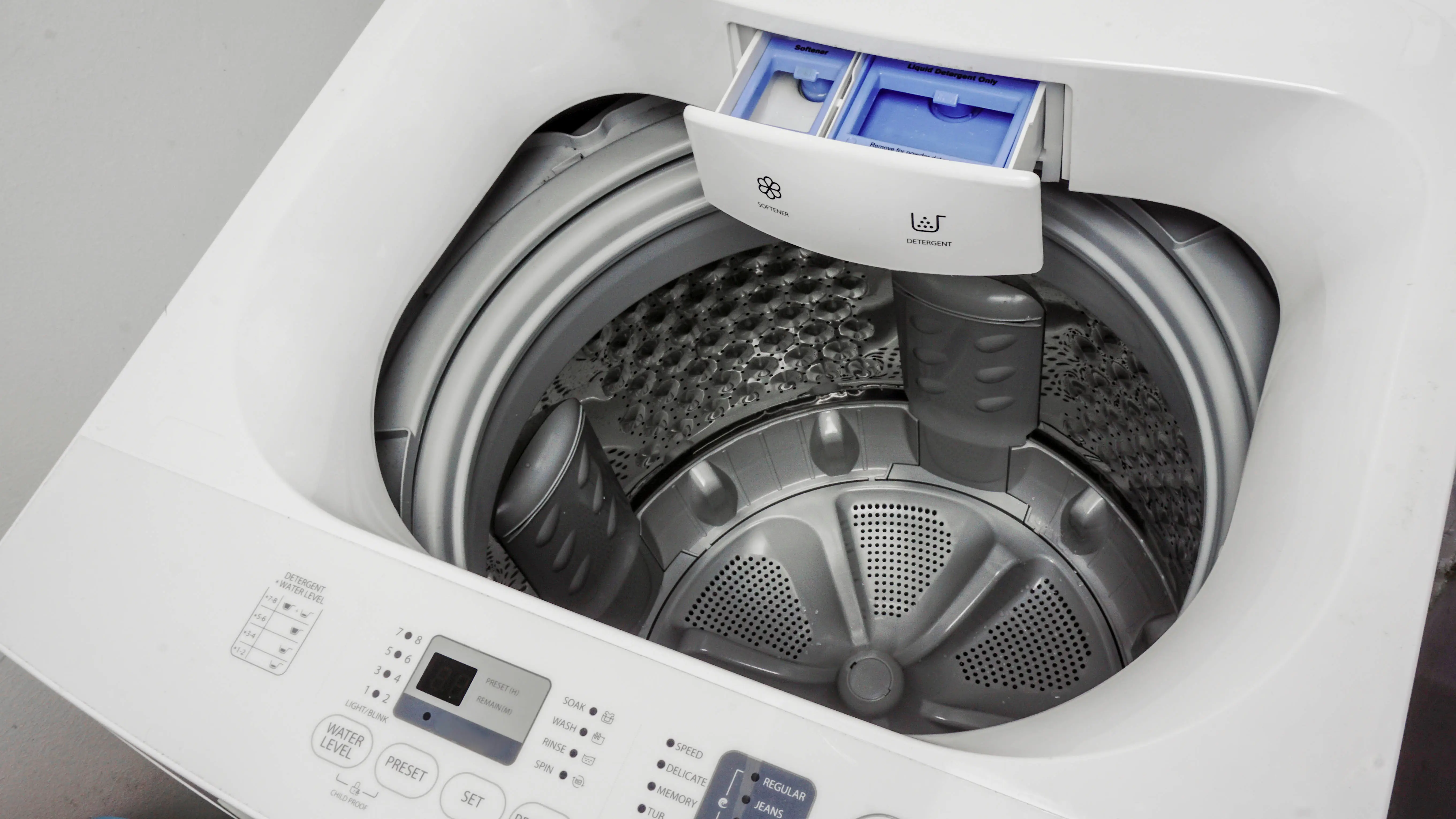 top load washing machine with open detergent and fabric softener compartments